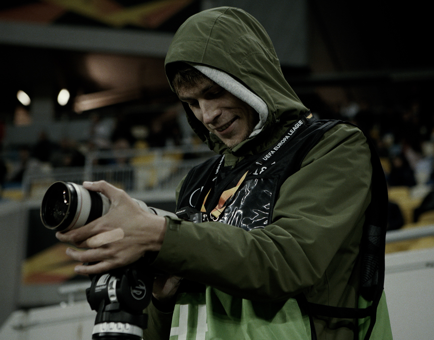 Alex Melnykov with a camera at a stadium